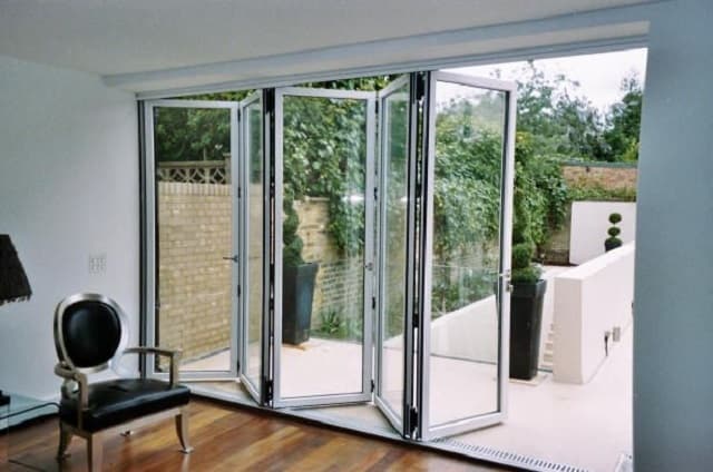 Folding patio glass doors opening onto a landscaped outdoor patio