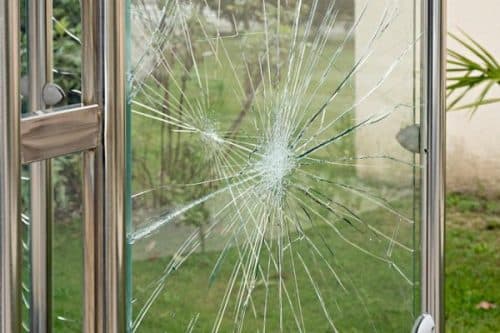 Shattered sliding glass door with a large section of tempered glass missing