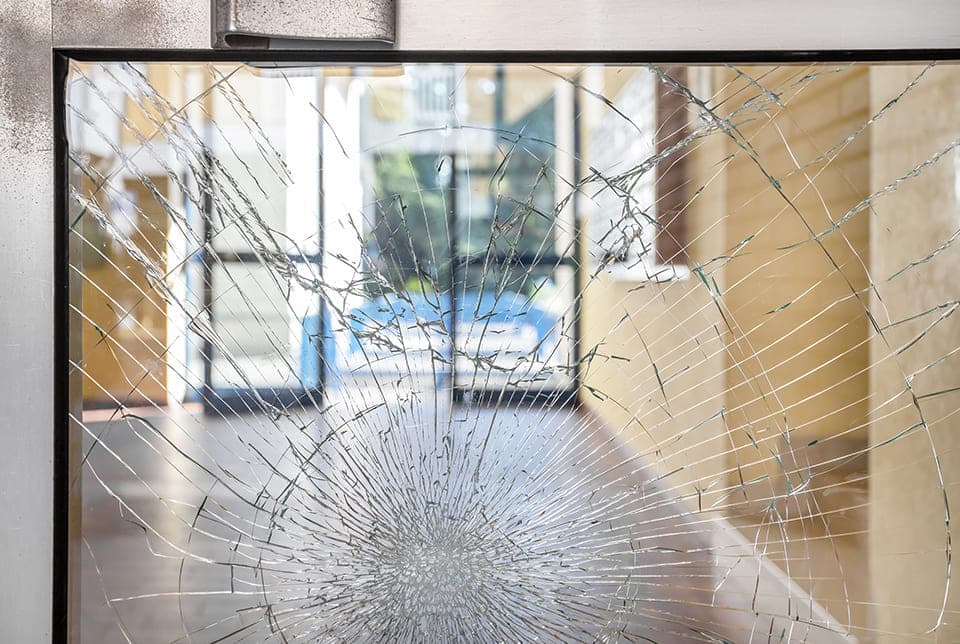 Shattered commercial glass panel in a metal frame