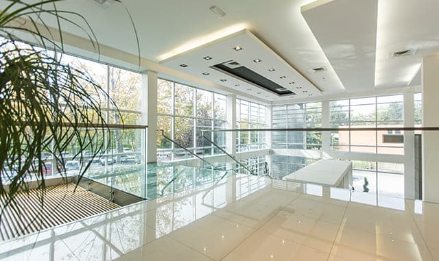 Viewrail-style glass panels along a commercial mezzanine with open views