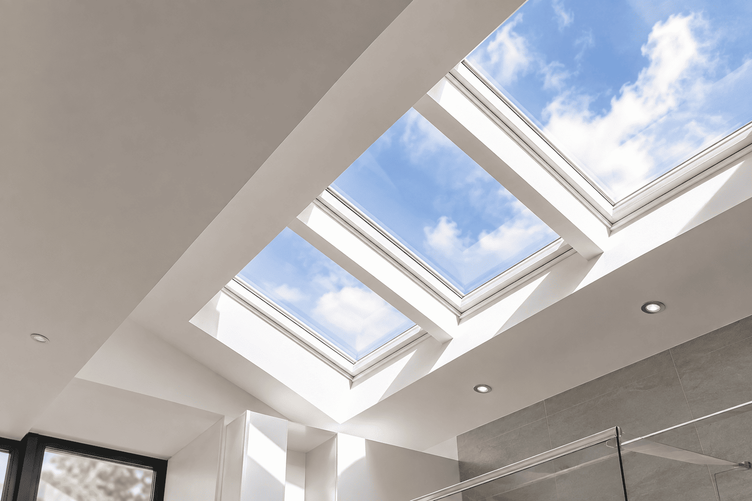 Technician installing a new skylight window into a white ceiling opening